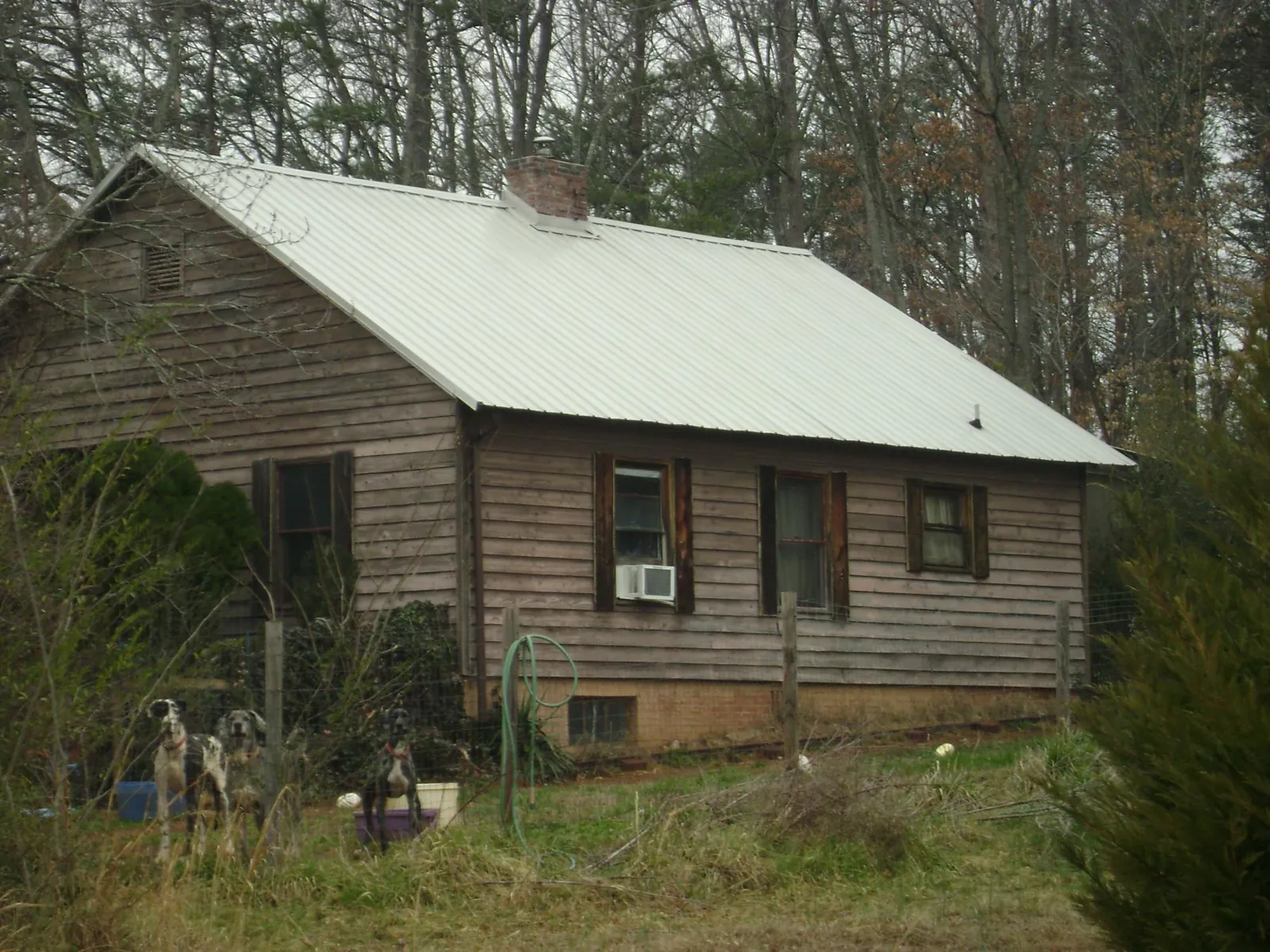 White metal roof on an old wood sided farmhouse, from a Metal Roof Installation job in Wilmington
